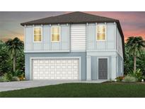 Two-story house with light blue exterior, white garage door, and landscaping at 6233 Golden Beach Dr, Apollo Beach, FL 33572