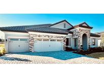 Two-story house with stone accents and a three-car garage at 10195 Meadowrun Dr, Lithia, FL 33547