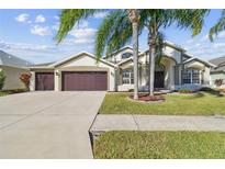 Beautiful one-story home with a two-car garage and lush landscaping at 10338 Meadow Crossing Dr, Tampa, FL 33647