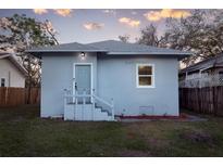 Newly renovated bungalow with light blue exterior, front steps, and a landscaped yard at 1045 22Nd N Ave, St Petersburg, FL 33704