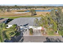 Aerial view of single-story home with two-car garage, situated on a golf course at 1312 Leland Dr # 61, Sun City Center, FL 33573