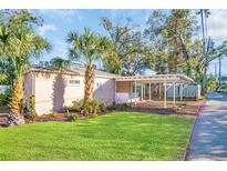 Updated home exterior with a carport and nicely landscaped lawn at 2514 Ohio S Ct, Gulfport, FL 33707