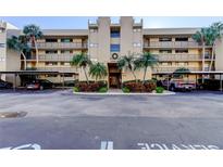 Condo building with parking and lush landscaping at 2614 Cove Cay Dr # 409, Clearwater, FL 33760