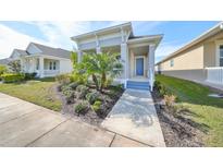 Single-story home with front porch and landscaped yard at 727 Winterside Dr, Apollo Beach, FL 33572