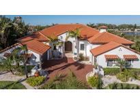 Luxury waterfront home with a brick driveway and lush landscaping at 751 34Th Ne Ave, St Petersburg, FL 33704