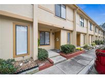 Tan exterior of townhome with landscaping and parking at 1449 Highland Ridge Cir, Brandon, FL 33510