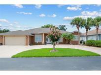 Attractive single-story home with circular driveway and landscaping at 29242 Caddyshack Ln, San Antonio, FL 33576