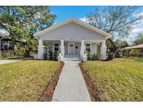 Charming renovated bungalow with gray siding, white trim, and a landscaped lawn at 3105 N 17Th St, Tampa, FL 33605