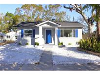 Newly renovated home with gray exterior, blue door, and white rock landscaping at 419 40Th S Ave, St Petersburg, FL 33705