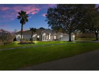 Beautiful home with a large yard, three-car garage, and mature landscaping at 456 Diamond Dr, Spring Hill, FL 34609