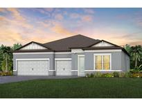 Two-story home with gray exterior, three-car garage, and landscaped lawn at 6136 Jensen View Ave, Apollo Beach, FL 33572