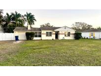 Ranch-style home with a large front yard and a single-car garage at 6202 S Jones Rd, Tampa, FL 33611