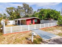 Newly renovated home with red brick accents and a white picket fence at 7206 E Emma St, Tampa, FL 33610
