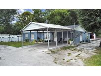 Cute blue house with carport and a spacious backyard at 8106 N Rome Ave, Tampa, FL 33604