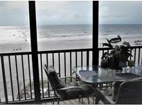 Stunning ocean view from private balcony, featuring table and chairs at 20040 Gulf Blvd # 302, Indian Shores, FL 33785