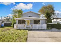 Charming single-story home with a white picket fence and well-maintained lawn at 7140 62Nd N Way, Pinellas Park, FL 33781
