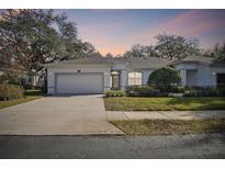 Inviting one-story home with a two-car garage and landscaped front yard at 8529 Alexandra Arbor Ln, Temple Terrace, FL 33637