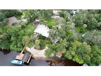 Aerial view of house, expansive lawn, and private dock on the river at 11554 Monette Rd, Riverview, FL 33569