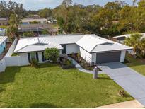 Aerial view of a renovated mid-century modern home with a large yard at 1448 S Hercules Ave, Clearwater, FL 33764