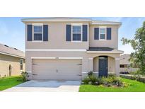 Two-story house with neutral siding, shutters, and a two-car garage at 16748 Trite Bend St, Wimauma, FL 33598