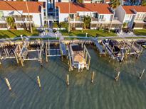 Aerial view of waterfront property with boat slips and private docks at 175 Medallion Blvd # F, Madeira Beach, FL 33708