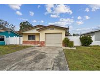 Brick ranch home with attached garage and driveway at 1885 Mississippi Ne Ave, St Petersburg, FL 33703