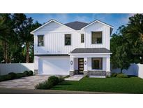 Two-story white house with gray roof, two-car garage, and landscaped yard at 3424 Ohio Ave, Tampa, FL 33611