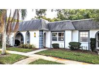 Charming light-grey exterior condo with well-maintained landscaping and walkway at 4214 Trucious Pl, New Port Richey, FL 34652
