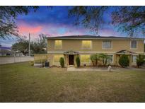 Two-story townhome with a landscaped lawn and a covered patio at 10817 Keys Gate Dr, Riverview, FL 33579