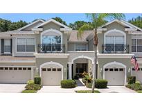 Two story townhome with attached garage and neutral color scheme at 14215 Waterville Cir, Tampa, FL 33626