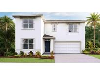 Two-story house with a two-car garage and landscaping at 2883 Gardiner Ln, Zephyrhills, FL 33541