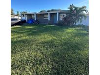 Ranch style home with a large grassy front yard at 3222 Saint John St, Tampa, FL 33607