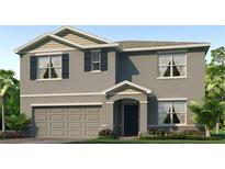 Two-story home with gray siding, dark shutters, and a two-car garage at 35237 Valley Ridge Rd, Dade City, FL 33525