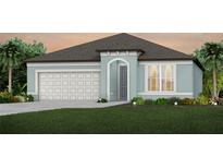Single-story home with light blue exterior, white garage door, and landscaping at 4177 Feldspar Ln, Spring Hill, FL 34609