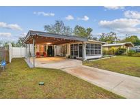 Cute ranch home with carport and landscaped yard at 7210 E Cayuga St, Tampa, FL 33610