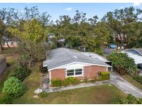 Brick home with a spacious yard, bird bath, and detached shed at 7918 Croton Ave, Tampa, FL 33619