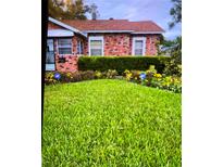 Brick house with well-maintained lawn and landscaping at 2504 Highland S St, St Petersburg, FL 33705