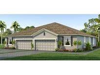 Two-story home with a three-car garage and landscaped lawn at 32660 Rustic Rise Rd, San Antonio, FL 33576