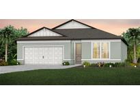 Single-story home with a two-car garage and landscaping at 4176 Feldspar Ln, Spring Hill, FL 34609