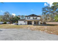 Two-story home with covered porch and large backyard at 14450 Lancer Rd, Spring Hill, FL 34610