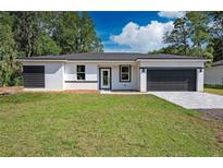 New construction home with gray accents and a two-car garage at 14469 Bulger Ave, Port Charlotte, FL 33953