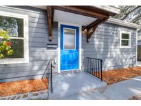 Gray house exterior with blue front door, walkway, and landscaping at 2859 38Th N Ave, St Petersburg, FL 33713
