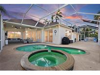 Inviting pool and spa area with covered patio and outdoor lighting at 4531 Swordfish Dr, Bradenton, FL 34208