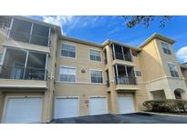 Condo building with multiple units, garages, and balconies at 5125 Palm Springs Blvd # 6106, Tampa, FL 33647