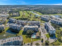 Aerial view of a condo community with pool, golf course, and lake at 960 Starkey Rd # 5301, Largo, FL 33771