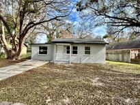 Newly renovated house with a landscaped yard and driveway at 1426 E Mulberry Dr, Tampa, FL 33604