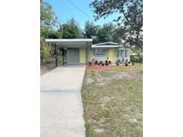House exterior with carport and landscaping at 1605 E Bougainvillea Ave, Tampa, FL 33612