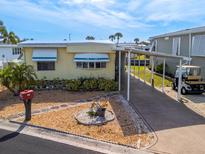 Single-wide manufactured home with carport and landscaped yard at 170 S Saint Thomas Cir, Apollo Beach, FL 33572