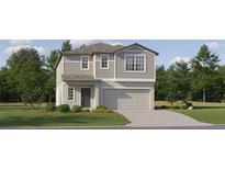 Two-story house with gray siding, a two-car garage, and landscaping at 17574 Shirewood Way, Land O Lakes, FL 34638