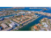 Aerial view of waterfront community with lush landscaping and private boat slips at 262 Madeira Cir, Tierra Verde, FL 33715